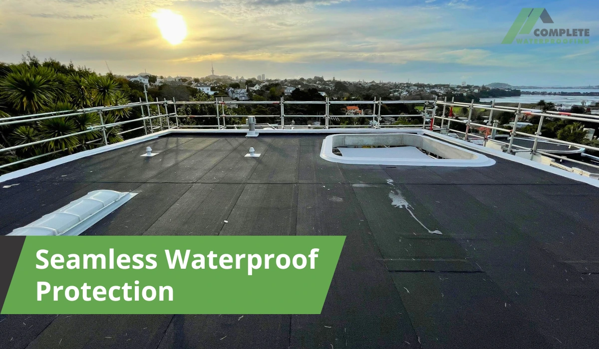 Worker rolling out waterproof membrane on wooden roof decking for installation.